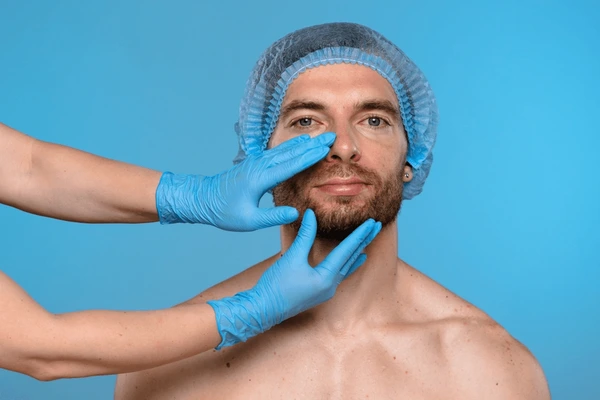 Medical professional examines male patient nose 600nw