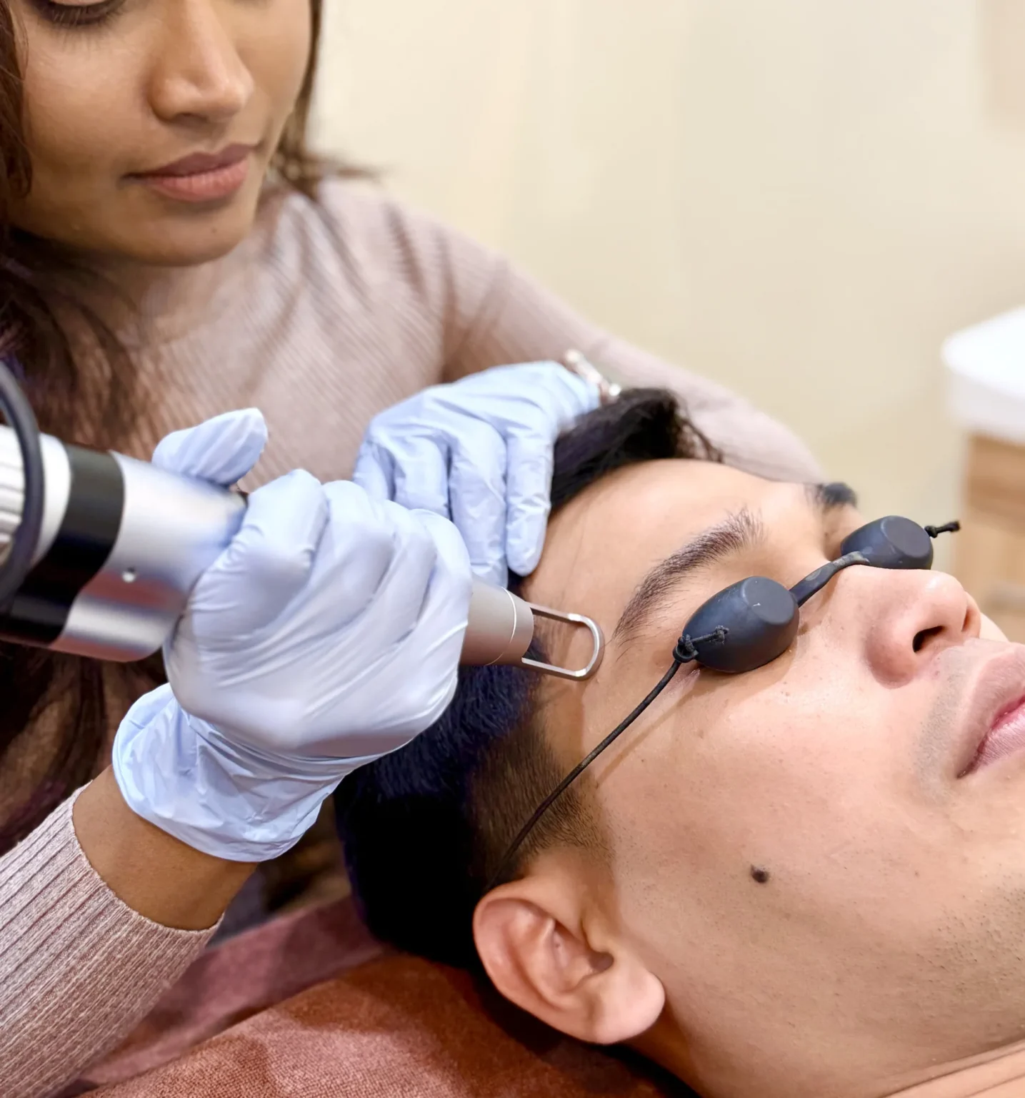 Doctor performing a pico laser treatment on a male patient wearing protective eyewear at Vivardi Clinics Rawang